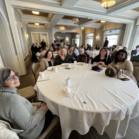A table of attendees smile for the camera!